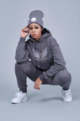 A woman wearing Women affordable hoodies and tracksuits and a beanie.