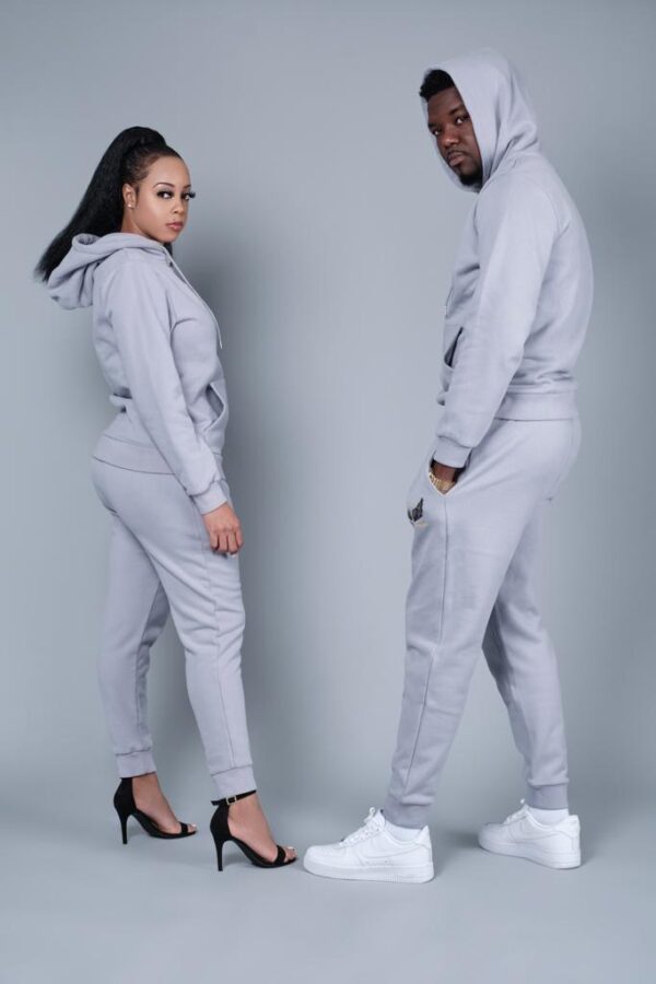 A man and woman posing in affordable unisex hoodies, soft & comfortable sweatpants.